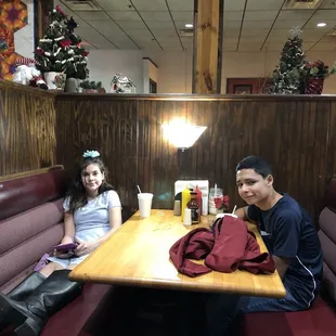 two people sitting at a booth
