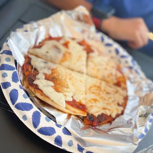 a pizza on a paper plate