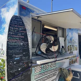 a food truck with a menu written on it
