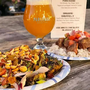 a plate of food and a glass of beer