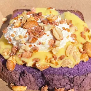 a purple cake with nuts on top