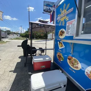 a blue food truck with food on it