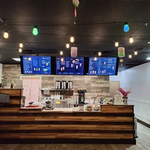 a coffee shop counter with a variety of menus