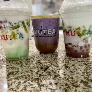 three cups of different flavored drinks