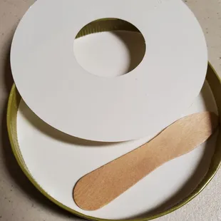 Wooden spoon inside lid of their packaged ice cream