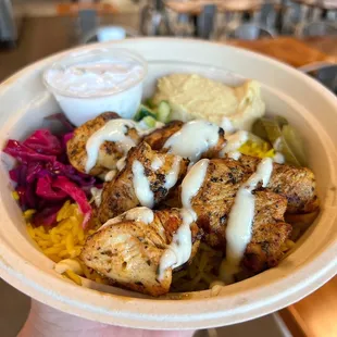 a hand holding a bowl of food