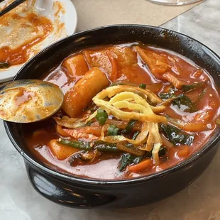 Dukbokee - Rice cakes and veg simmered in sweet spicy sauce