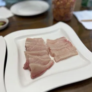 two plates of raw fish