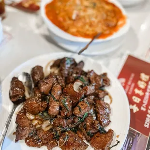 a plate of beef and noodles