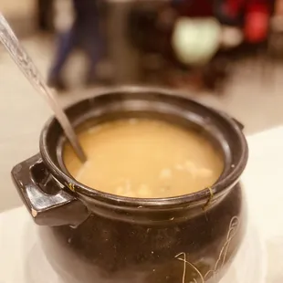 a pot of soup with a spoon in it