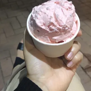 a person holding a bowl of ice cream