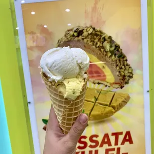 a hand holding an ice cream cone