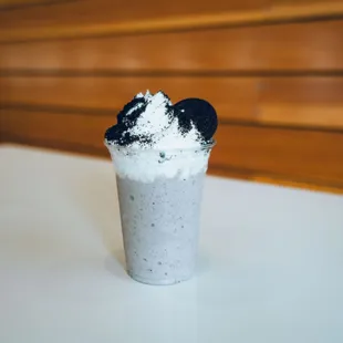 Oreo Milkshake Topped With Oreo Crumble And Whole Oreo