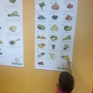 a little girl looking at a menu