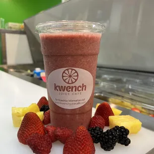 a smoothie with berries and pineapples