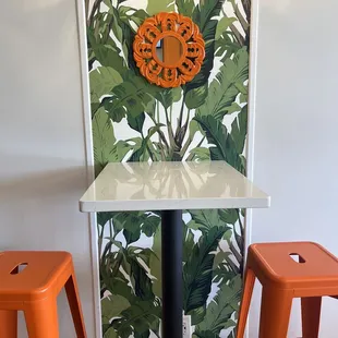 a table with orange stools