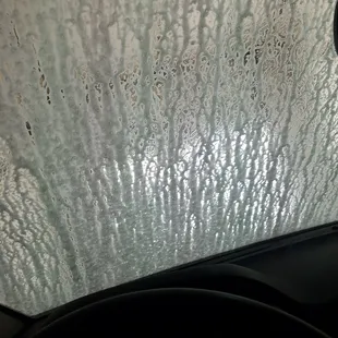 a car&apos;s windshield covered in rain