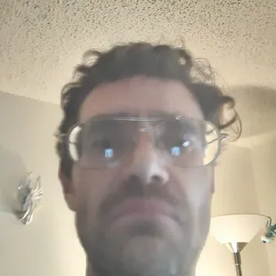 a selfie of a man wearing glasses