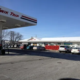 cars parked in front of a gas station