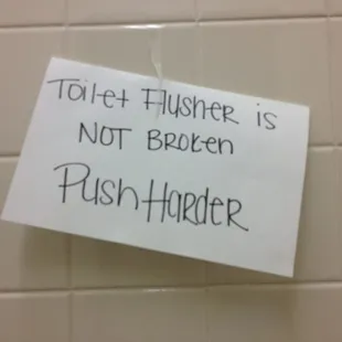 a note attached to a toilet