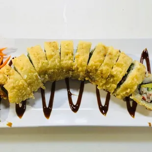 a variety of sushi on a white plate