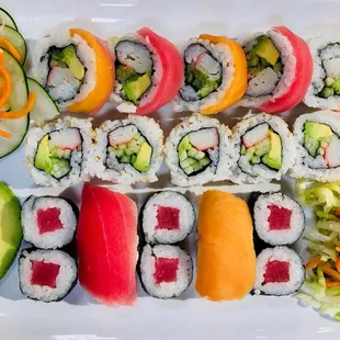 a variety of sushi on a white plate