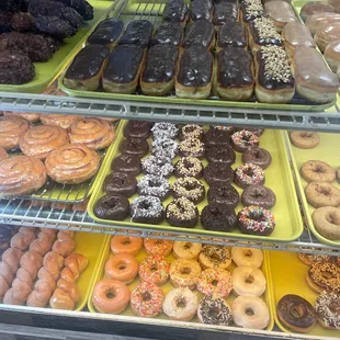 a variety of donuts in a display case