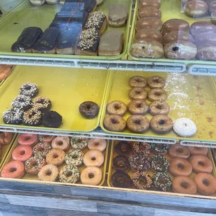 a variety of donuts in a display case