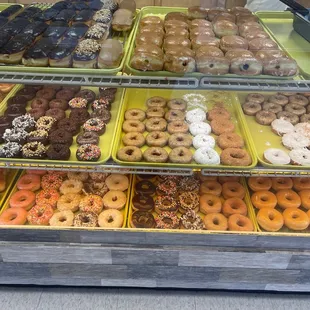 a variety of donuts in a display case