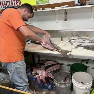 skilled fishmonger fillets fresh grouper