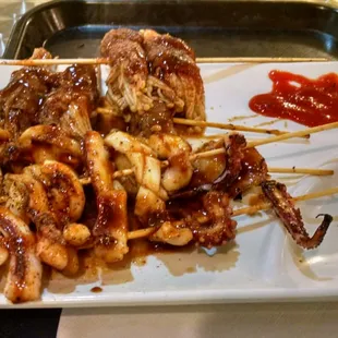 Mushroom, and cuddle fish and, tentacle skewers. Not mind blowing but good flavor.