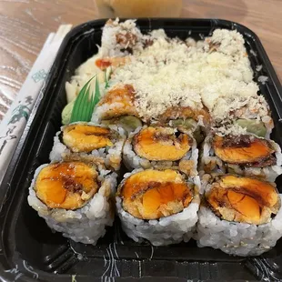 a tray of sushi and a glass of beer