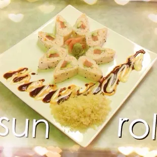 a plate of sushi and rice with the words sun roll