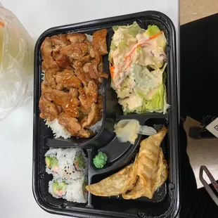 Chicken Bento Box....Contains teriyaki chicken, California sushi roll, steamed rice, three dumplings, and a side salad.