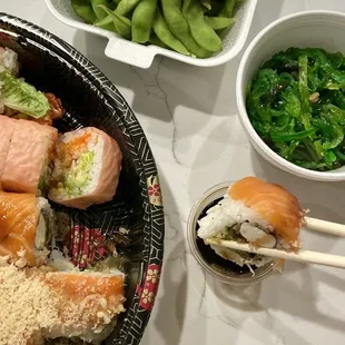 a plate of sushi and a bowl of green beans