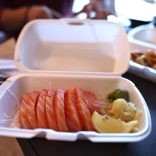 salmon and vegetables in a styrofoam container