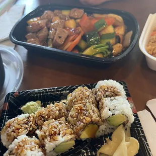 a plate of sushi with rice and vegetables