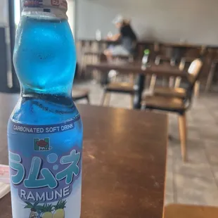 a bottle of blue liquid on a table