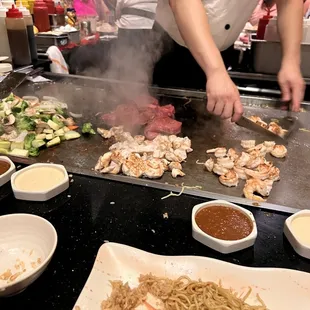a chef cooking on a grill