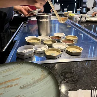 Dipping sauces being ladled