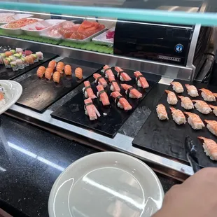 a sushi buffet with various types of sushi