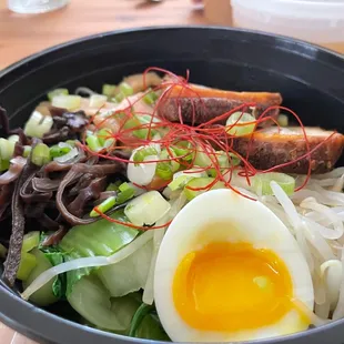 a bowl of ramen noodles and an egg