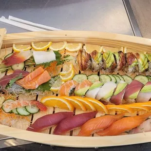 a wooden boat with sushi on it