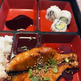 Salmon bento lunch box -comes with 4 pieces California roll and spring roll and one gyoza and salad (or soup)
