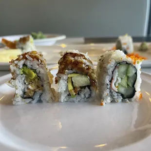 The three sushi rolls I ordered - L to R - shrimp tempura roll with cream cheese, eel roll, rainbow roll (tune sliver on top removed).