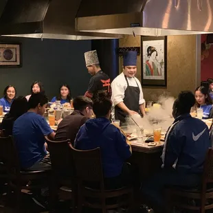 a group of people sitting around a table