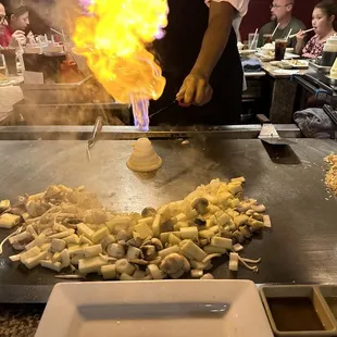 a person cooking food on a grill