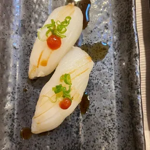 two pieces of sushi on a plate