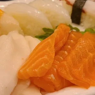 a variety of sushi on a white plate