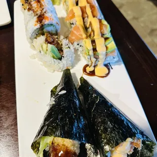 a plate of sushi and rolls